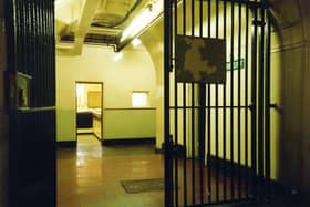 A view from gates in the Leeds Bridewell in the Town Hall, looking straight ahead to the desk in the Custody Officer's Room where prisoners would be taken on arrival. Inside the doorway, left, there is access to a passage leading to the 1864 Police entrance between two Keyworth Lions on the West side of the Town Hall frontage on The Headrow.
