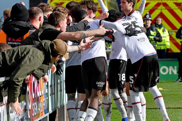 Walsall fans and players celebrate Priestley Farquharson's winner