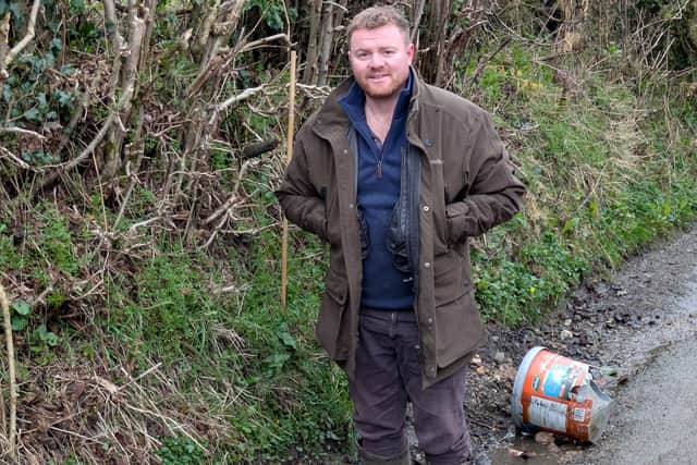 Bryn Robinson shows how deep one pothole is in Church Preen. Picture: LDRS
