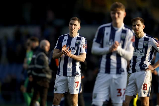 Baggies players including youngster Bostock, foreground, and captain Jed Wallace, rear left, and Jayson Molumby receive the ire of the angry away fans at full-time. (Photo by Adam Fradgley/West Bromwich Albion FC via Getty Images)
