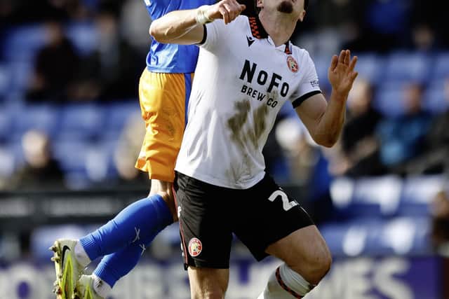 Taylor Perry (left) challenges Jamie Jellis for a header
