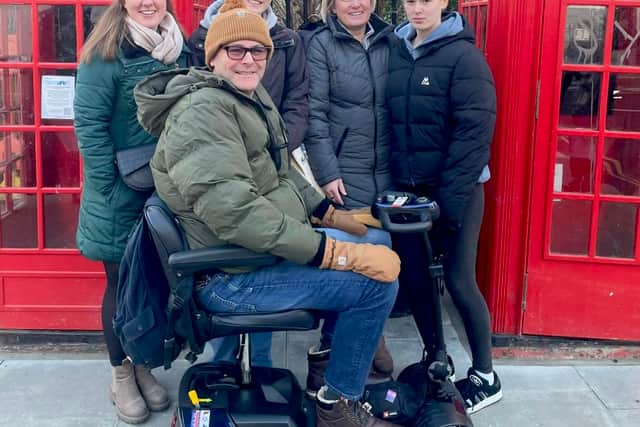 Dylan in his mobility scooter with, from left: stepdaughter Megan, Ameila, Louise and Ella Rose on a recent trip to London