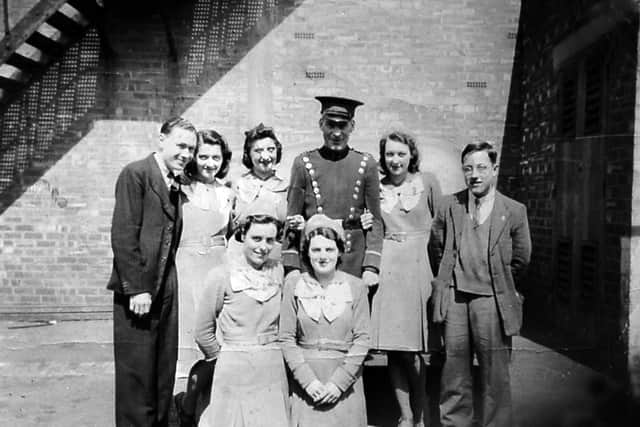 Clifton cinema staff in 1941. The album caption is: 'Some members of the staff at the Clifton cinema, Wellington, in 1941. Fred Brown, Edna Taylor, Helga Rosenberg, Fred Jones, don't know, Ron Rigby. Front: Mary Taylor, Molly Butler.' This picture was shared by Mrs Lynne Purcell, and is another from the collection of her late father Fred Brown.