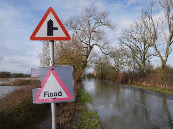 A flood warning sign on a flooded road. Picture date: Monday February 9, 2026. (Joe Giddens/PA)