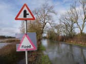 A flood warning sign on a flooded road. Picture date: Monday February 9, 2026. (Joe Giddens/PA)
