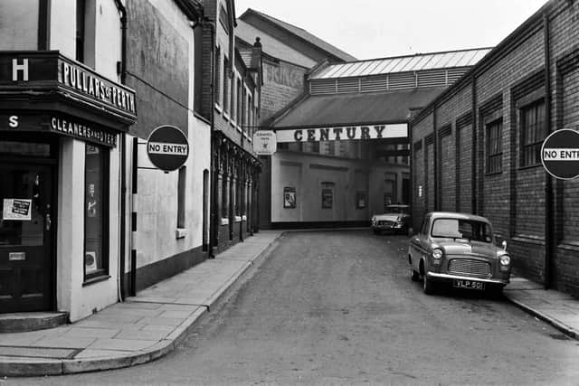 New Street, Oswestry, looking towards the Century Cinema, with the Cross Market on the right and the Grapes Inn on the left. This picture is used in the book Oswestry Through Time by David Trumper which says the cinema opened as the King's Hall in 1914. The caption gives no date but it looks to be about 1960. The book caption says the cinema became the Granada Bingo Club and in 1998 was converted into a Wilkinson hardware store. 