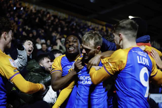 Taylor Perry and his Shrewsbury Town teammates celebrate against Notts County