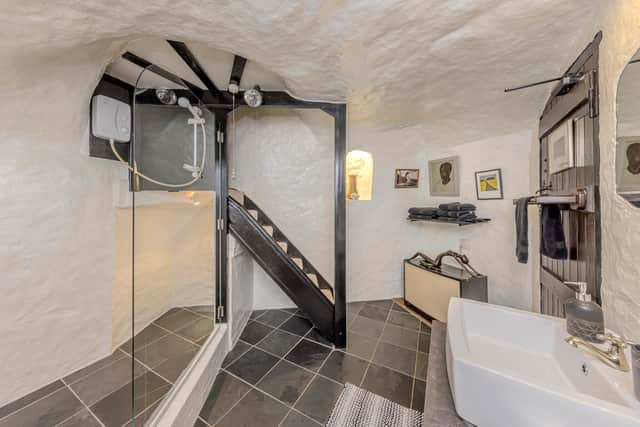 A stunning 16th-century West Midlands cottage built into a carved-out cave has gone on sale .
