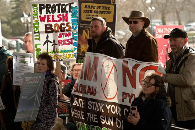 Many hundred opponents of plans by energy giants: Bute, Green GEN Cwmru and others, to build industrial scale wind farms throughout rural Wales, gather outside the Senedd for a mass protest organised by Llanwrtyd Wells Pylon Community Action Group, supported by Re-think.Wales