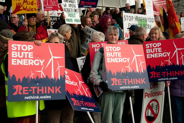 Many hundred opponents of plans by energy giants: Bute, Green GEN Cwmru and others, to build industrial scale wind farms throughout rural Wales, gather outside the Senedd for a mass protest organised by Llanwrtyd Wells Pylon Community Action Group, supported by Re-think.Wales and scheduled on the day of climate change, environment & infrastructure committee meeting