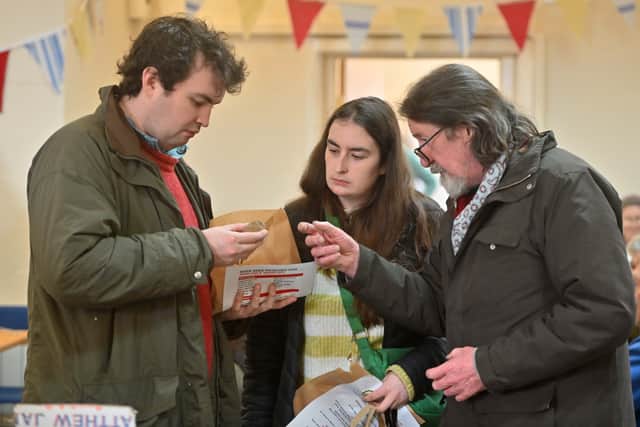 Examining the goods at potato day.