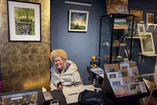Rose Roberts, all smiles behind the counter at Shrewsbury Arts and Crafts, the shop run at Perches House by her daughter, Jessica Richards