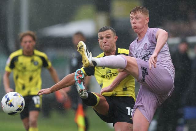 Sam Clucas of Shrewsbury Town and Jack Muldoon of Harrogate Town