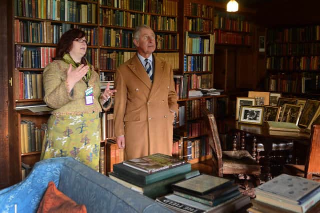 King Charles is shown around the library of Wightwick Manor with house steward Helen Bratt-Wyton