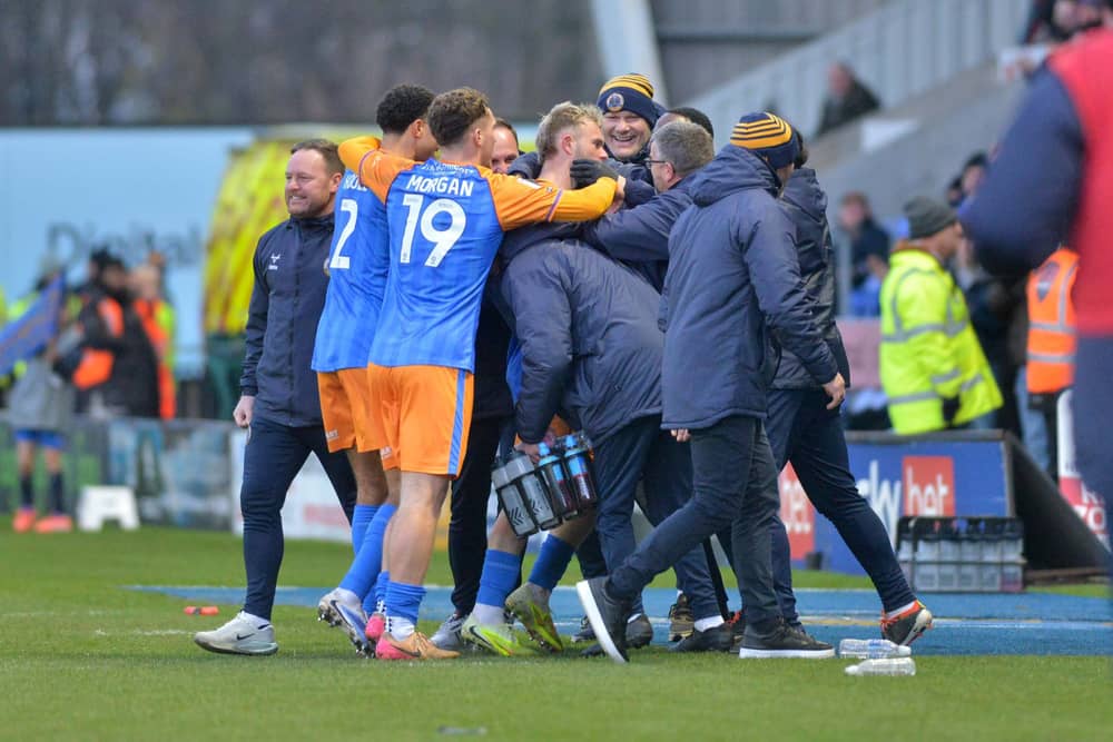 Taylor Perry celebrates with his Shrewsbury Town teammates after scoring