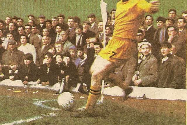 Terry Wharton taking a corner in front of the North Bank