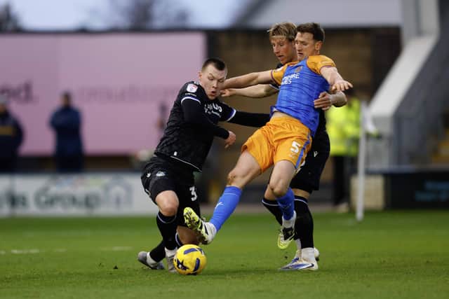 Jack Sparkes and Will Boyle compete during the game between Shrewsbury Town and Bristol Rovers at Croud Meadow on 1st January 2026