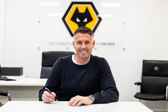 Rob Edwards signs his contract to become the new Wolves head coach. (Picture: Getty Images)