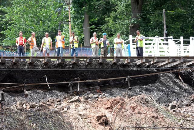 Severn Valley Railway workers looks at the damage caused the flash floods