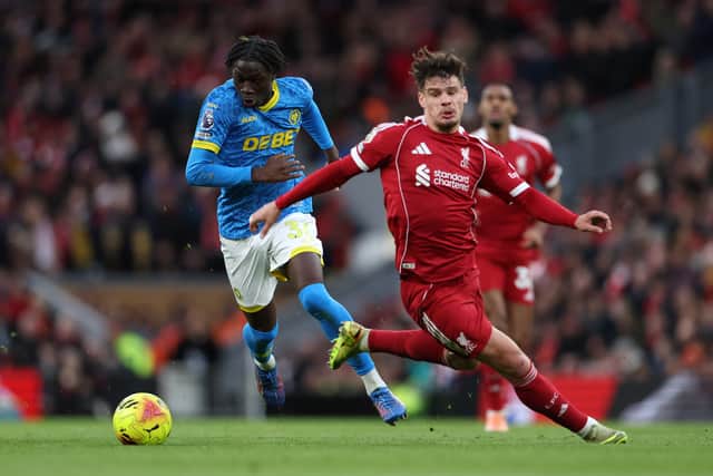 LIVERPOOL, ENGLAND - DECEMBER 27: Mateus Mane of Wolverhampton Wanderers runs with the ball whilst under pressure from Milos Kerkez of Liverpool during the Premier League match between Liverpool and Wolverhampton Wanderers at Anfield on December 27, 2025 in Liverpool, England. (Photo by Brett Patzke - WWFC/Wolves via Getty Images)