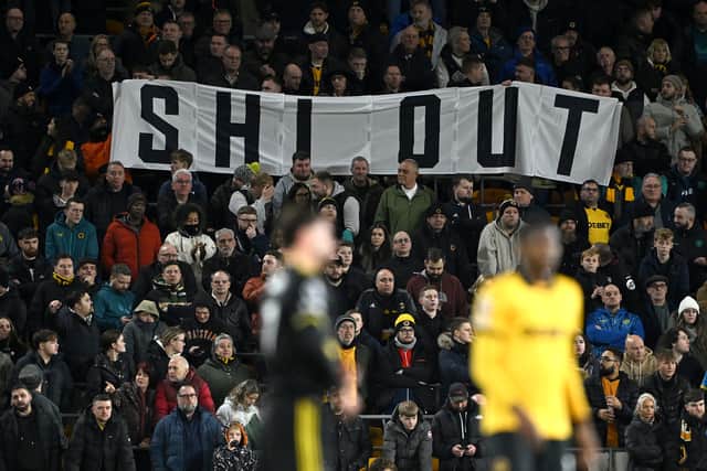 Wolves fans hold up a protest banner reading "Shi Out" during the Premier League match between Wolves and Manchester United at Molineux on December 8 (Photo by Shaun Botterill/Getty Images)