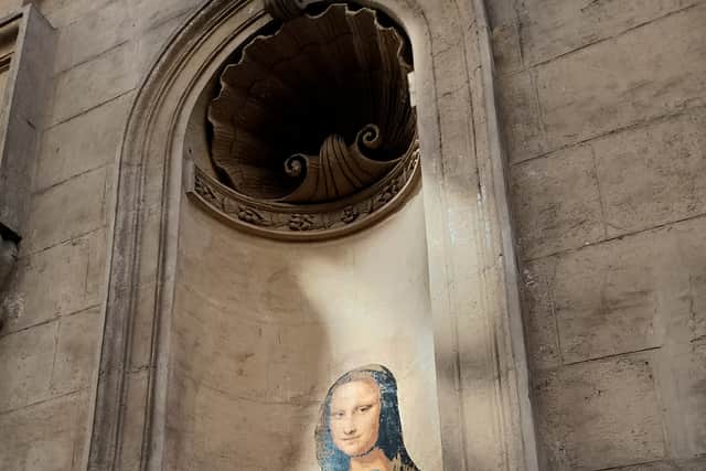 Mona Lisa takes a selfie on one of the many examples of 'street art' murals around the city
