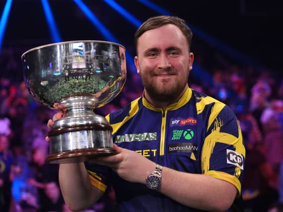 Littler lifts the trophy after winning the Grand Slam of Darts final in Wolverhampton (Martin Rickett/PA)