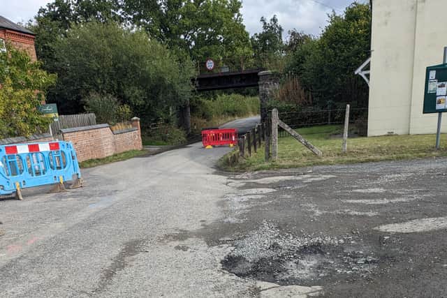 The road has been left pot holed