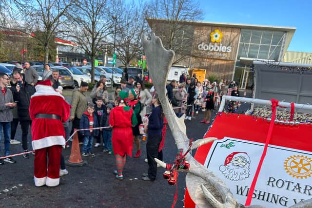 Santa is greeted by children and parents at Dobbies Garden Centre.