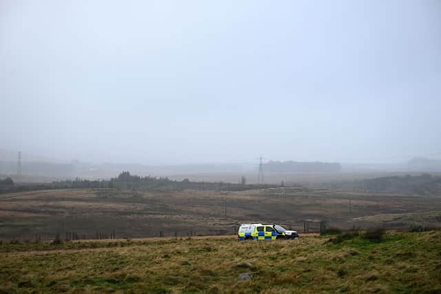 A police car is pictured near to where an Avanti West Coast train, travelling from Glasgow to London Euston sation, derailed, near Shap, north west England on November 3, 2025.