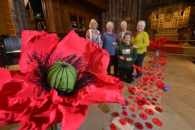 2023: 'Shrewsbury Abbey and the Shropshire Federation of the WI have been busy making Poppies for a lovely display.' In the lime green is the designer of the display Tina Carser, with her is Gilli Booton (kneeling), Sue Shedden, Josephine Bennett and Veronica Pryce. The purple poppies represent animals
