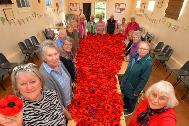 2022 - Bucknell Memorial Hall, Bucknell. A display of poppies  created by a local WI members, including (front left) Debbie Pope, and (front right) Sylvia Meredith