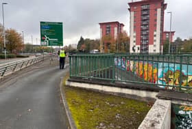 A West Midlands Police officer removes police tape from the scene