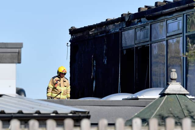 Firefighters assess damage to the St Martins School building