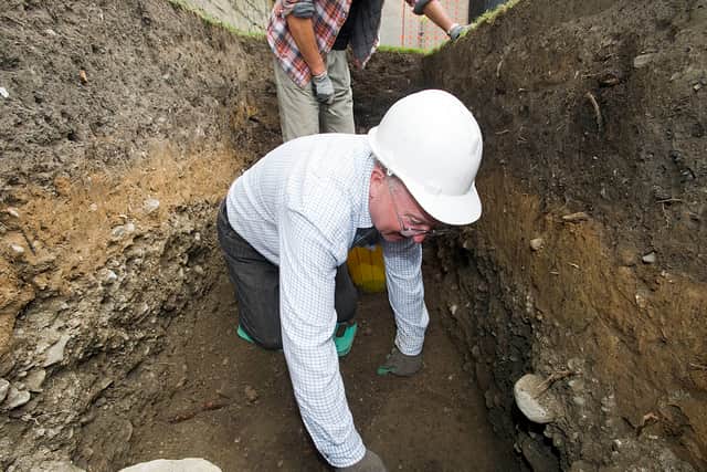 An archaeological dig at Oswestry's motte and bailey castle behind the Guildhall by members of Oswestry Archaeological Society. Volunteer Graham Thompson digs in the trench.