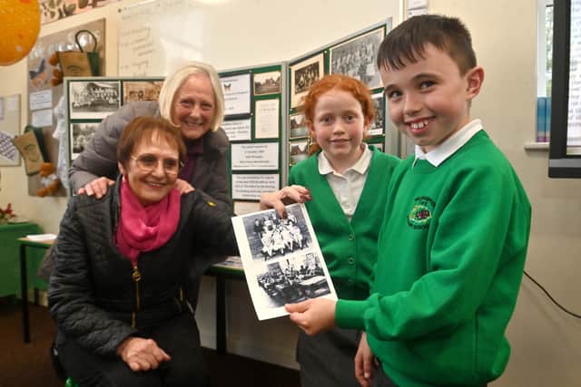 Former pupils and sisters Ruth Clarke and Jean Nicholas are joined by current pupils Bella and Kaden as they find themselves on an old photo. Photo: Steve Leath
