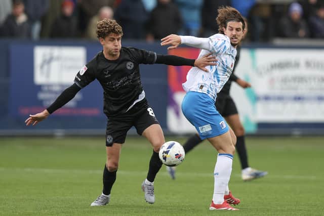 Harrison Biggins competes for the ball in the stalemate at Barrow - and now Town turn their attentions to a first home win since February 1.