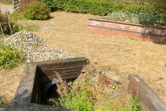 Drains in the garden adjacent to the lagoon site struggle to cope with frequent floods. Picture: Chris Naylor