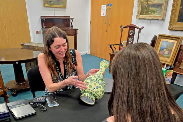 Maryanne Lineker-Mobberley valuing a vase.
