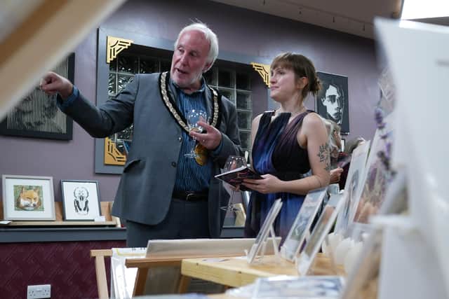 The Mayor of Kington Councillor Philip Sell and Vicki Larratt from the Old Picture House in Kington admiring the exhibits at the private view. Image by Andy Compton