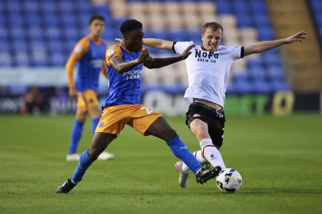 Walsall midfielder Ryan Finnigan, who scored the opener, challenges for the ball.