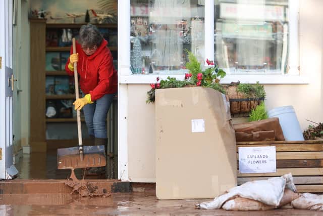People cleaning up after the flooding in Tenbury Wells