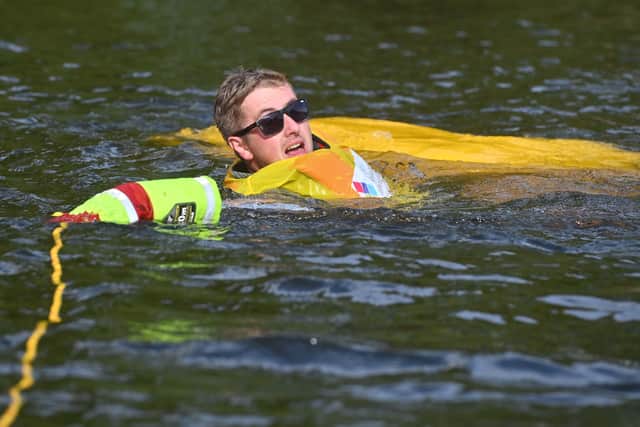A racer keeps his cool in the river after tumbling into the water