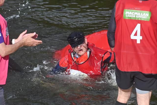 A drenched racer emerges from the River Severn