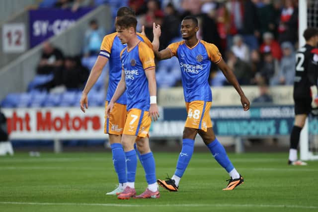 Bradley Ihionvien of Shrewsbury Town celebrates with his team mates after scoring a goal to make it 1-1