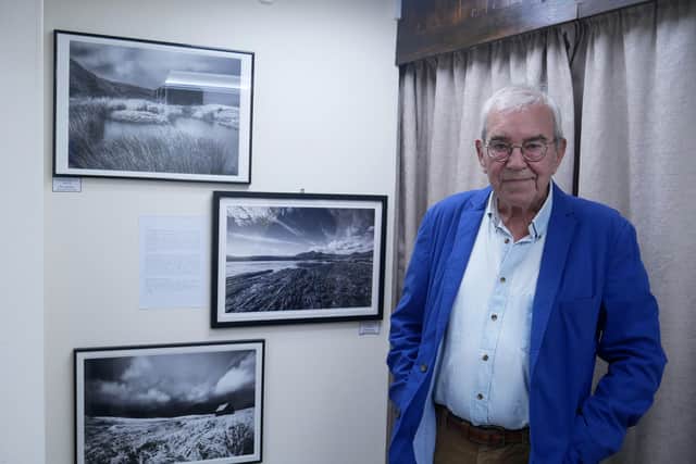Renowned photographer Richard Surman with three of his exhibits at the Old Picture House in Kington. Image by Andy Compton