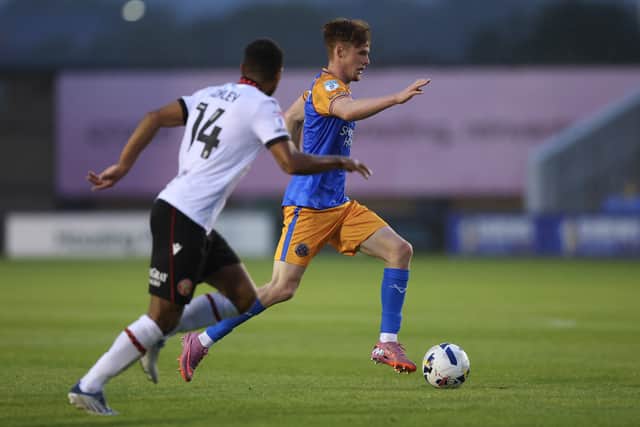 Tommy McDermott of Shrewsbury Town and Brandon Comley of Walsall