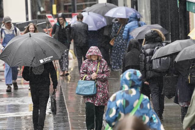 People walk in the rain.