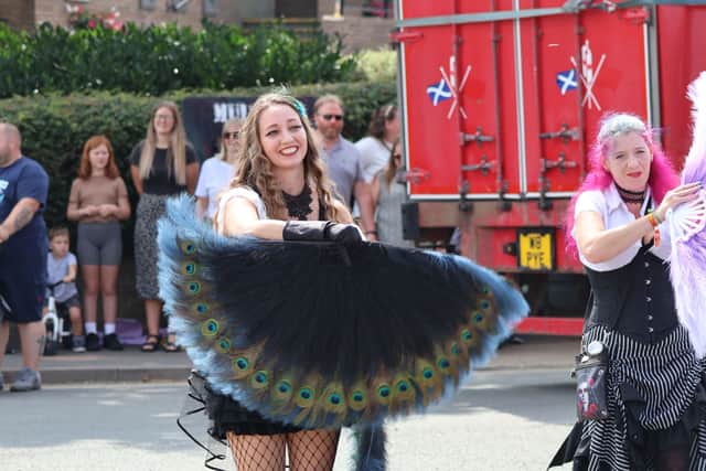 This carnival-goer was all smiles as she flapped her feathers. Pictures: Sue Austin