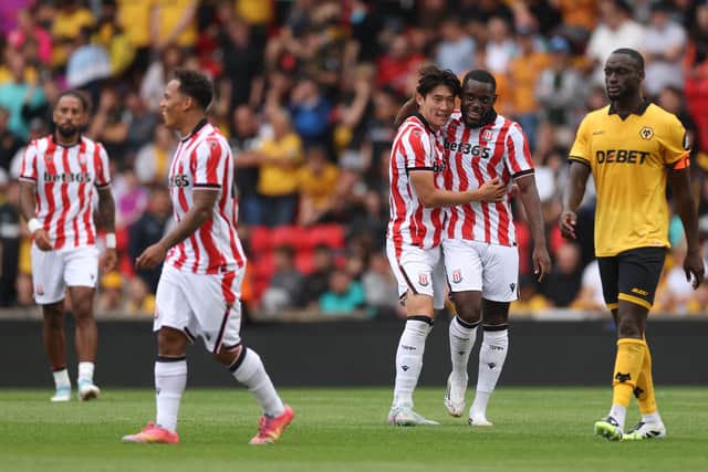 STOKE ON TRENT, ENGLAND - JULY 26: Bae Jun-ho of Stoke City celebrates scoring his team's first goal with teammate Junior Tchamadeu during the pre-season friendly match between Stoke City and Wolverhampton Wanderers at Bet365 Stadium on July 26, 2025 in Stoke on Trent, England. (Photo by Carl Recine/Getty Images)